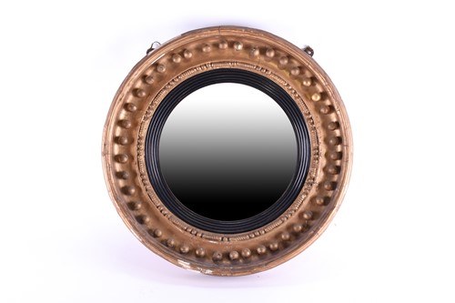 Lot 187 - A Regency convex giltwood wall mirror with...