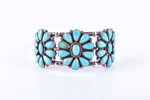 Lot 742 - An American white metal and turquoise bangle...