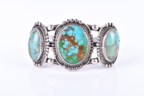 Lot 881 - An American white metal and turquoise bangle...
