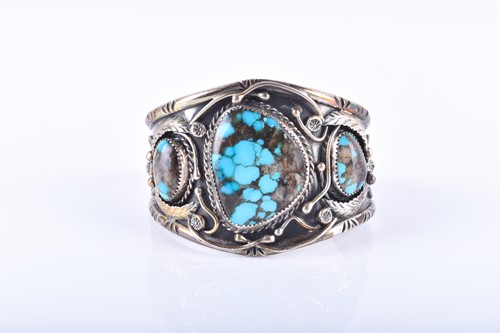 Lot 823 - An American white metal and turquoise bangle...