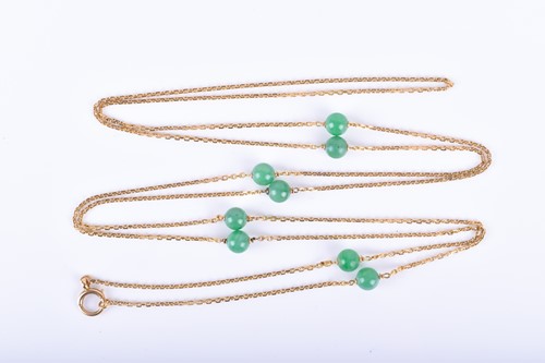 Lot 781 - An opera length yellow metal chain suspended...