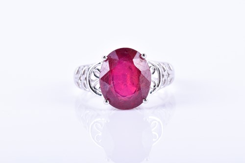 Lot 733 - A 14k white gold and ruby ring set with a...