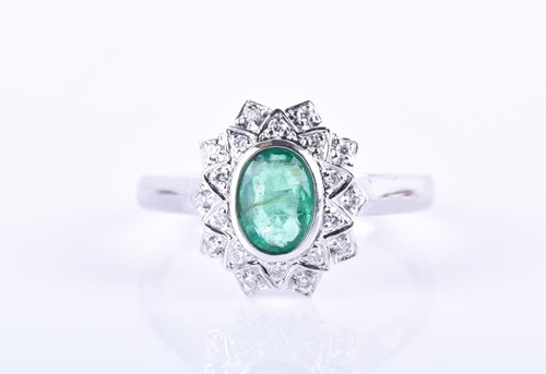 Lot 854 - A 14k white gold, diamond, and emerald cluster...