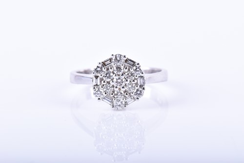Lot 701 - An 18ct white gold and diamond circular...