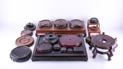 Lot 222 - A collection of Chinese carved hardwood stands,...