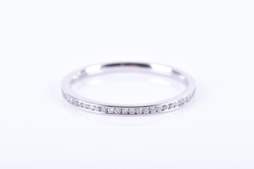 Lot 531 - A platinum and diamond eternity ring,...