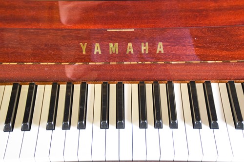 Lot 173 - A Yamaha upright piano with high gloss finish,...
