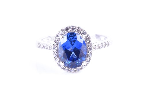 Lot 779 - A white gold, white sapphire and blue stone...