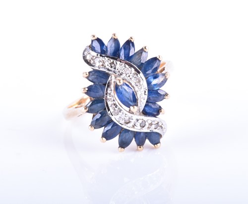 Lot 856 - A yellow metal, diamond, and sapphire cluster...