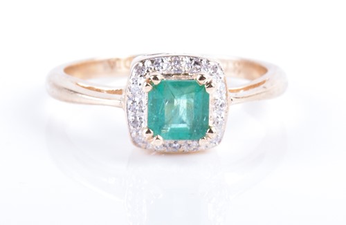 Lot 791 - A 9ct yellow gold, diamond, and emerald ring...