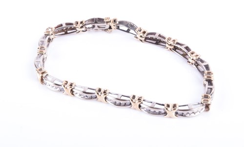 Lot 829 - A white and yellow metal and diamond line...