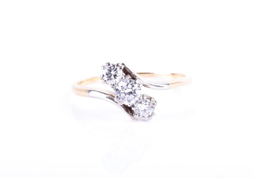 Lot 851 - An 18ct yellow gold and diamond crossover ring...