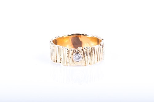 Lot 760 - A yellow metal and diamond ring the band of...