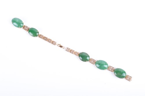 Lot 766 - A yellow metal and jadeite bracelet in the...