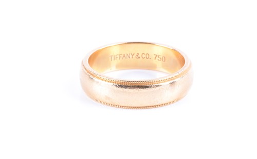 Lot 868 - A yellow metal wedding band ring engraved...