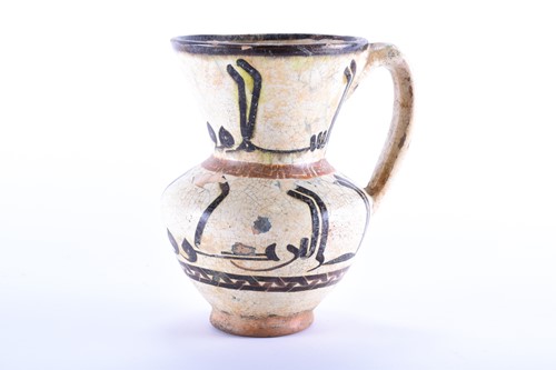 Lot 169 - An early Islamic tin glazed ewer, with...