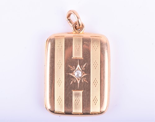 Lot 882 - A 15ct yellow gold and diamond locket with...
