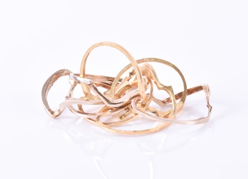 Lot 914 - A yellow metal puzzle ring comprising of eight...