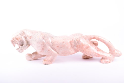 Lot 286 - A large pink hardstone model of a panther n...