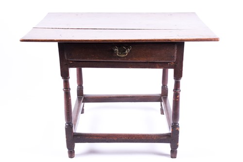 Lot 74 - A George III oak lowboy, on turned and block...