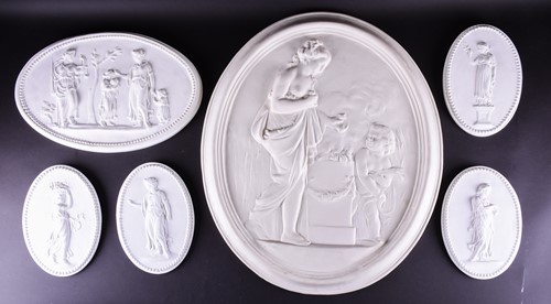 Lot 252 - A large 18th century style oval plaster relief...