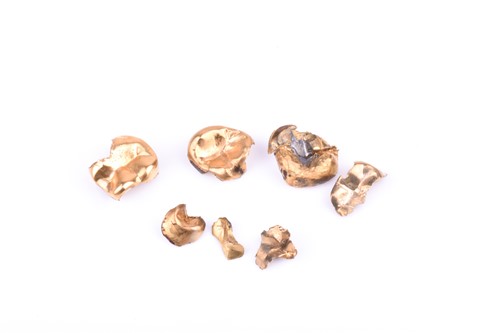 Lot 503 - A small collection of yellow metal tooth...