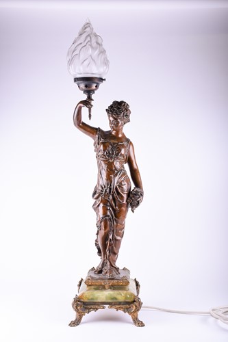 Lot 299 - A large patinated spelter table lamp, modelled...
