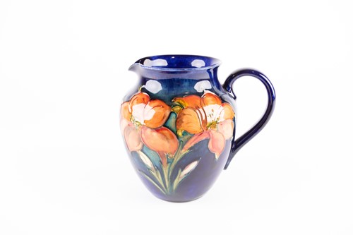Lot 50 - A Walter Moorcroft Freesia pattern jug, the...