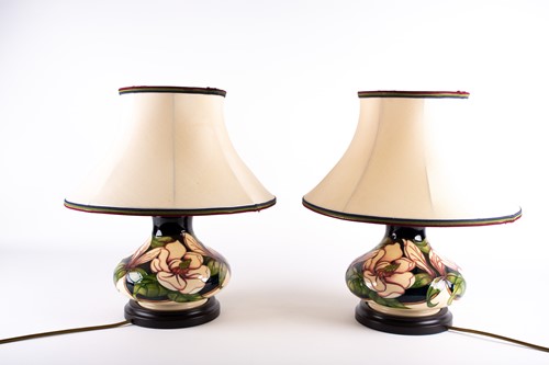 Lot 270 - A pair of Moorcroft 'Magnolia' pattern table...