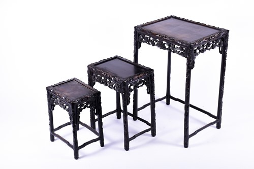 Lot 134 - A Chinese carved hardwood nest of three...