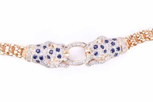 Lot 720 - An unusual yellow metal, sapphire, and diamond...