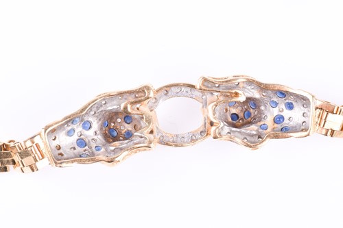 Lot 720 - An unusual yellow metal, sapphire, and diamond...