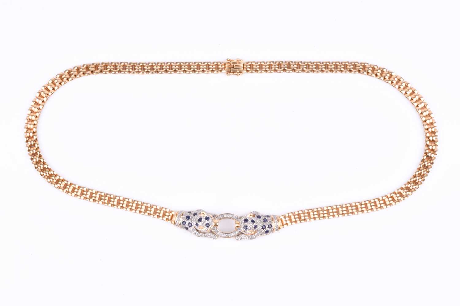 Lot 720 - An unusual yellow metal, sapphire, and diamond...