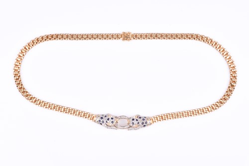Lot 720 - An unusual yellow metal, sapphire, and diamond...