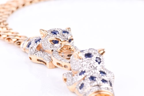 Lot 720 - An unusual yellow metal, sapphire, and diamond...