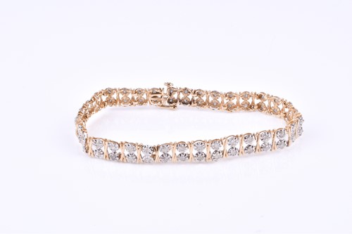 Lot 790 - A 9ct yellow gold and diamond bracelet, the...