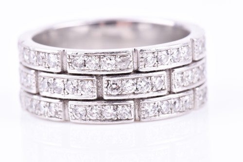Lot 231 - A diamond eternity ring, the white metal mount...