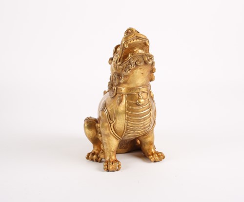 Lot 244 - A Chinese gilt metal Bixi, seated on its...