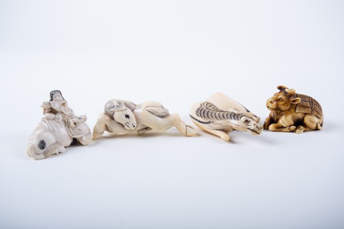Lot 127 - Three Japanese ivory netsuke and an okimono,...