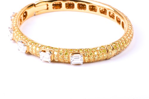 Lot 218 - Graff. An 18ct yellow gold and diamond bangle,...