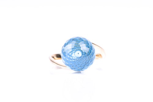 Lot 386 - A blue topaz dress ring, the multi-faceted...