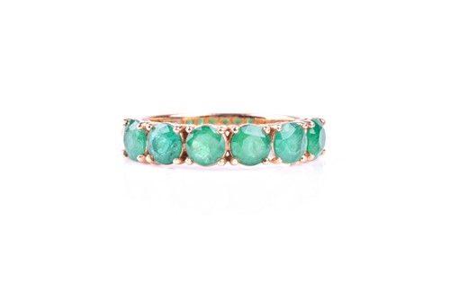 Lot 412 - A six stone emerald ring, the circular cut...