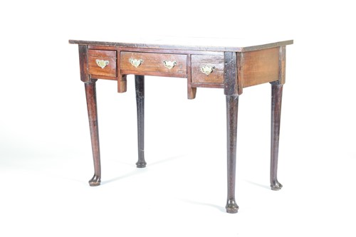 Lot 134 - A Georgian oak lowboy, 19th century, with...