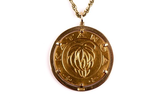 Lot 258 - A yellow metal Banque National 5 Franc coin,...