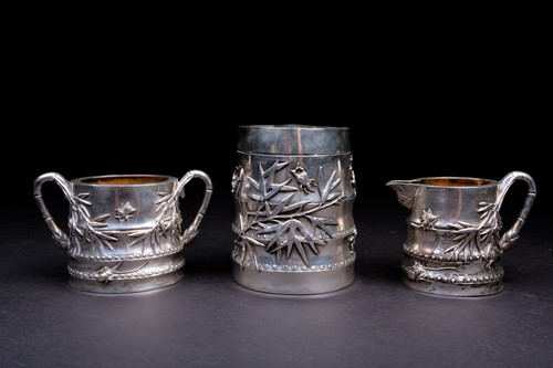 Lot 140 - A Chinese silver tea caddy, sugar bowl and...