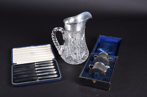 Lot 38 - A silver mounted cut glass water pitcher,...