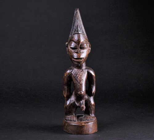 Lot 22 - A Yoruba Ibeji standing male figure, his chest...
