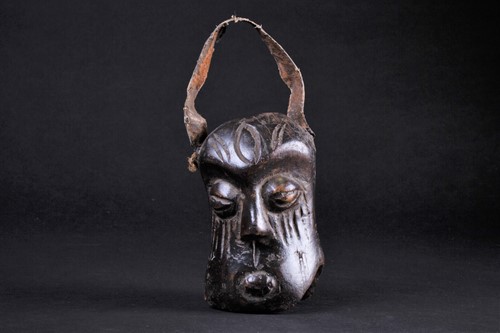 Lot 54 - An African carved wood miniature mask/bell,...