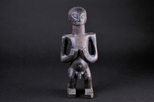 Lot 38 - An East African standing male fertility figure,...