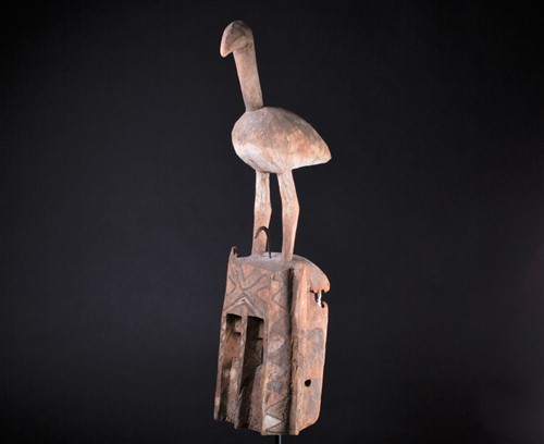 Lot 34 - A Dogon mask, Mali, surmounted by a large bird...